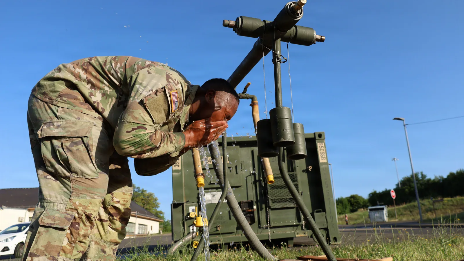 Ein US-Soldat kühlt sein Gesicht mit Wasser an einer Trinkwasserstation während einer Hitzewelle in Baumholder.